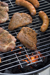 Sausages and Hamburgers on barbecue grill