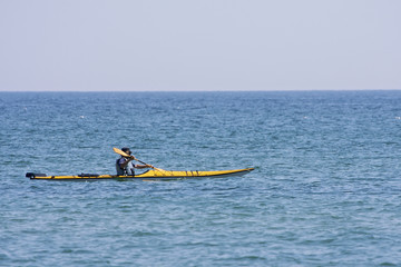 Yellow sea kayak being paddled across a Great Lake