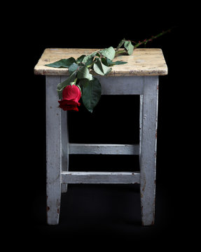 Flowers and old a stool on a white background