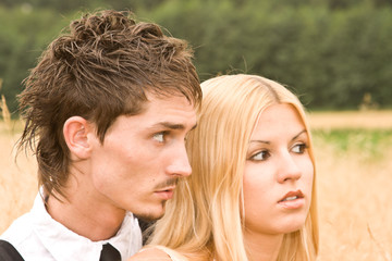 Couple in meadow looking at something