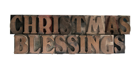 the words 'Christmas blessings' in old, ink-stained wood type