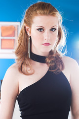 A young woman looks glamorous in a black evening dress