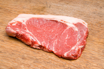 Red and Tasty Steak on a Wooden Table