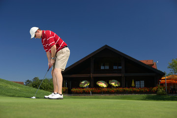 putting on beautiful golfcourt with place for text