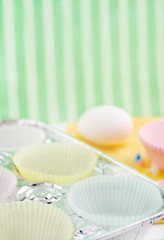 cupcake paper cups in baking pan with egg