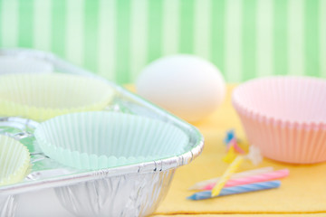 cupcake paper cups in baking pan with egg