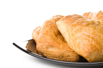 Fresh rolls on a plate on a white background