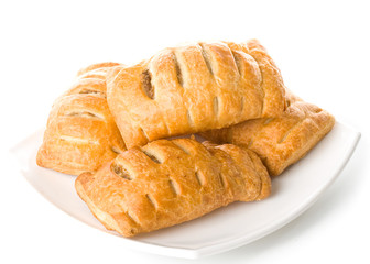 Fresh rolls on a plate on a white background