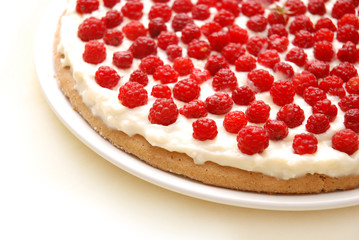 Appetizing raspberry tart on white plate.