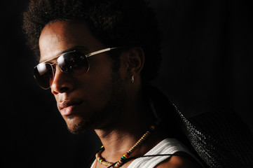 Portrait of young trendy african male with sunglasses