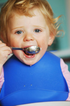 A little girl eating her meal