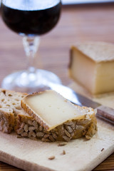 A french tasty slice of cheese on a piece of bread with cereals