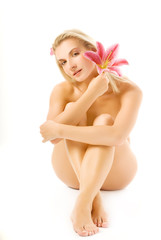 Obraz premium Beautiful young woman with pink lily flower