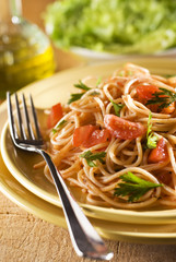fresh spaghetti with tomato sauce on a plate close up