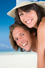 Happy young couple smiling on the tropical beach
