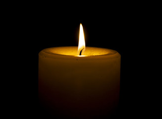 Candle on black background