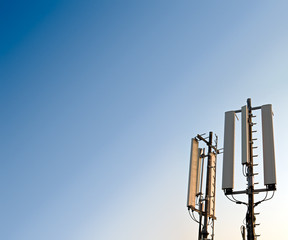 GSM mobile antenna detail against a blue sky.