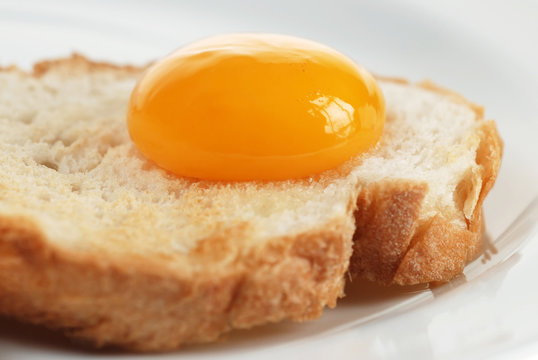 Broken egg on bread, beauty of yellow