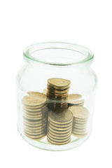 Stacks of Coins in Glass Jar on White Background