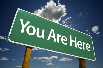 You Are Here Road Sign with dramatic clouds and sky.
