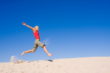 beautiful female exercising on the sand dunes