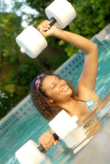Healthy young woman doing water aerobics