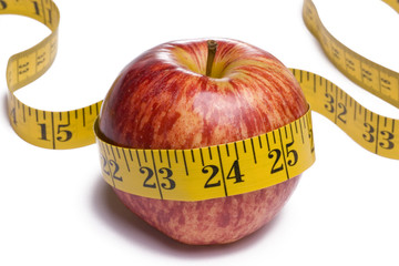 Apple with tape measure around on white background