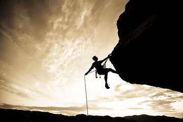 Rock climber rappelling.