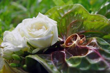 Marriage bouquet with golden rings on the leaf