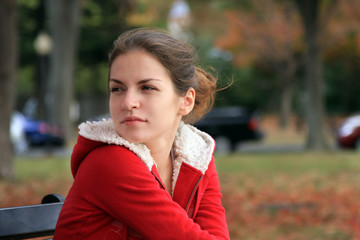 A portrait of a young woman in an autumn park
