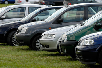 Cars parked on the green grass - 9071469