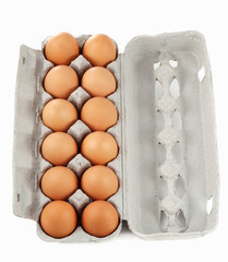 dozen of fresh brown eggs on container