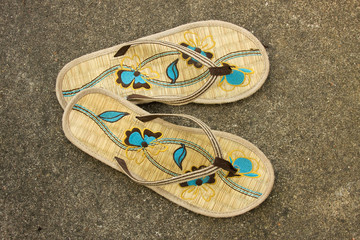 Pair of flip-flops isolated on concrete pavement