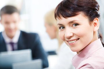 Close-up of happy businesswoman looking at camera