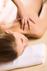 Obraz na płótnie Canvas beauty portrait of a young woman getting a massage