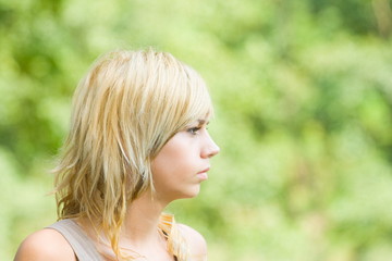 Naklejka premium Portrait of a beautiful blond girl outdoors