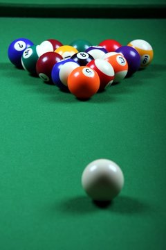 Pool balls on green felt table at the beginning of a game
