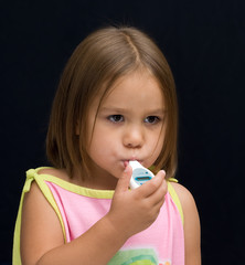 A sick kid with a thermometer in her mouth