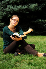 Fototapeta premium Student Reading in a public park