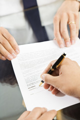 Fototapeta premium Businessman holding agreement for signature. Close up