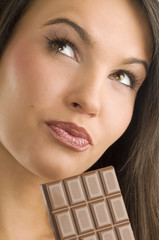 close up of a young and beautiful girl looking up with chocolate