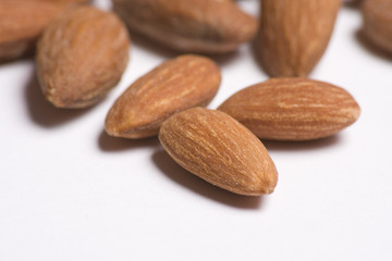 Almonds close up on white background with selective focus