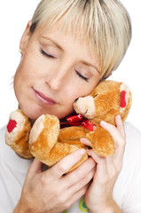 young blond girl with tedy bear close up