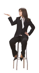 Fototapeta premium Young businesswoman sitting on a high chair
