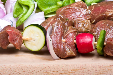 getting ready to make shish kabobs raw meat and vegetables