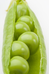 Fresh pods of peas on a white background