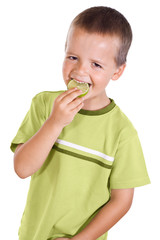 Happy boy eating a lime slice - isolated