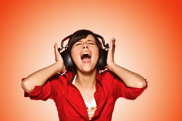 Young woman in headphones singing her favourite song