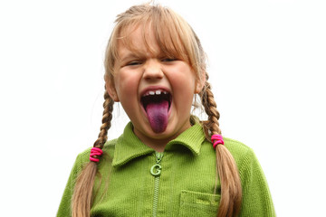 Girl showing her tongue after eating bilberries © Ints