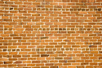 An old brick wall of orange and red bricks